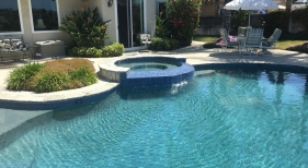 Freeform Pool with Raised Tiled Overflow Spa